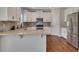 Kitchen with stainless steel appliances, white cabinets, granite counters and hardwood floors at 47 Whitley Ct, Dallas, GA 30157