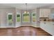 Breakfast nook with backyard views and kitchen featuring granite counters and white cabinets at 47 Whitley Ct, Dallas, GA 30157