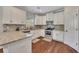 Kitchen featuring stainless steel appliances, white cabinets, granite counters and hardwood floors at 47 Whitley Ct, Dallas, GA 30157