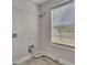 A laundry room with tile floors, shelving and a window with blinds at 47 Whitley Ct, Dallas, GA 30157