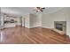 Open concept living room with hardwood floors, stone fireplace, and view of the kitchen at 47 Whitley Ct, Dallas, GA 30157