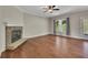 Cozy living room with a stone fireplace, hardwood floors, and natural light from the windows at 47 Whitley Ct, Dallas, GA 30157