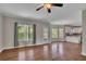 Living room with hardwood floors, large windows, backyard access, and view of the kitchen at 47 Whitley Ct, Dallas, GA 30157
