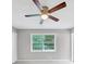Bedroom boasts a ceiling fan and window providing light and air circulation at 563 Navarre Dr, Stone Mountain, GA 30087