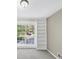 Sun-lit bedroom showcases a window and built-in shelving creating a cozy space at 563 Navarre Dr, Stone Mountain, GA 30087