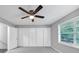 Spacious bedroom with a ceiling fan, a window, and a closet, perfect for relaxing at 563 Navarre Dr, Stone Mountain, GA 30087