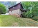 Exterior side view of a two story house with a stairway leading to a wooden deck at 563 Navarre Dr, Stone Mountain, GA 30087