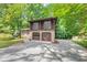 Charming two-story home with a two-car garage, beautiful brickwork, and a long driveway at 563 Navarre Dr, Stone Mountain, GA 30087