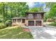 Charming two-story home with a two-car garage, beautiful brickwork, and a well-manicured front yard at 563 Navarre Dr, Stone Mountain, GA 30087