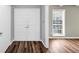 Inviting foyer with double doors, wood-look flooring, and a bright window, creating a warm entrance at 563 Navarre Dr, Stone Mountain, GA 30087