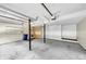 A view of the empty garage with cement flooring, shelves, and plenty of room for storage at 563 Navarre Dr, Stone Mountain, GA 30087