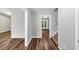 Hallway with wood-look floors leading to a staircase, a room and a patio with glass doors at 563 Navarre Dr, Stone Mountain, GA 30087