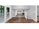 This hallway has a view of the living room area and hardwood flooring throughout at 563 Navarre Dr, Stone Mountain, GA 30087