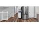 This kitchen shows a stainless steel refrigerator, white cabinets, and hardwood flooring at 563 Navarre Dr, Stone Mountain, GA 30087