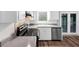 Bright kitchen features white cabinets, modern appliances, and a view of the backyard, perfect for cooking at 563 Navarre Dr, Stone Mountain, GA 30087