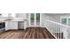 This modern kitchen has stainless steel appliances, white cabinets and hardwood flooring at 563 Navarre Dr, Stone Mountain, GA 30087