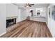 This is the living room with a brick fireplace, hardwood flooring, and a view of the kitchen at 563 Navarre Dr, Stone Mountain, GA 30087