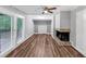 This is the living room with a brick fireplace, built in shelving and sliding glass doors at 563 Navarre Dr, Stone Mountain, GA 30087