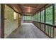 Spacious screened porch features wood floors and railings, offering a relaxing outdoor space at 563 Navarre Dr, Stone Mountain, GA 30087