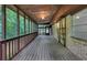 Expansive screened porch with wooden floors, brick and railing and outdoor ambiance at 563 Navarre Dr, Stone Mountain, GA 30087