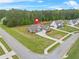 Aerial view showcasing a home with a well-maintained lawn in a wooded neighborhood at 100 Nemoura Ct, Fairburn, GA 30213