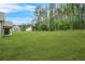 Spacious backyard featuring a lush green lawn and partial view of the home's exterior at 100 Nemoura Ct, Fairburn, GA 30213