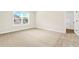 Bright bedroom with neutral walls, white trim and carpeted floors with a window offering outdoor views at 100 Nemoura Ct, Fairburn, GA 30213