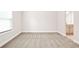 This room is an empty space that is freshly painted with neutral carpet flooring and a window for natural light at 100 Nemoura Ct, Fairburn, GA 30213