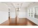 Elegant dining room with hardwood floors, coffered ceiling, and ample natural light at 100 Nemoura Ct, Fairburn, GA 30213