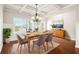 Bright dining room boasts a coffered ceiling, wood floors, stylish chandelier, and a large window at 100 Nemoura Ct, Fairburn, GA 30213