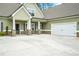 Stylish home with a wide driveway, stone accents, and an attached garage, creating great curb appeal at 100 Nemoura Ct, Fairburn, GA 30213