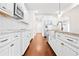 This kitchen boasts white cabinets, stainless appliances, subway tile backsplash, and granite countertops at 100 Nemoura Ct, Fairburn, GA 30213