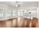 Open-concept space with hardwood floors, fireplace, and a kitchen area, perfect for entertaining at 100 Nemoura Ct, Fairburn, GA 30213