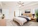 Bright main bedroom boasts stylish decor, natural light, and a cozy ambiance, creating a welcoming and comfortable retreat at 100 Nemoura Ct, Fairburn, GA 30213