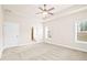 The spacious main bedroom is bright and airy, with neutral walls, carpet and ample natural light at 100 Nemoura Ct, Fairburn, GA 30213