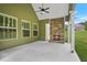 Covered patio with a stone fireplace, offering a cozy outdoor living space at 100 Nemoura Ct, Fairburn, GA 30213