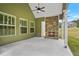 Covered patio with a stone fireplace, offering a cozy outdoor living space at 100 Nemoura Ct, Fairburn, GA 30213