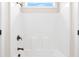 Bright bathroom featuring a shower with chrome fixtures and a window showing blue skies at 100 Nemoura Ct, Fairburn, GA 30213