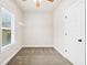 The empty walk-in closet includes shelving for clothing and storage and a window for natural light at 100 Nemoura Ct, Fairburn, GA 30213