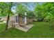 Backyard patio and lush greenery compliment this beautiful house with an easy-to-maintain lawn at 2015 Twelve Oaks Nw Cir, Kennesaw, GA 30144