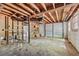 Unfinished basement with concrete floor and exposed wood rafters with garage door entry at 2015 Twelve Oaks Nw Cir, Kennesaw, GA 30144