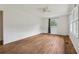 Bright, spacious bedroom with hardwood floors, a ceiling fan, and natural light from a large window at 2015 Twelve Oaks Nw Cir, Kennesaw, GA 30144