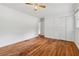 Spacious bedroom featuring hardwood floors, a ceiling fan, and a closet for ample storage at 2015 Twelve Oaks Nw Cir, Kennesaw, GA 30144
