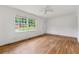 A well-lit bedroom showcases beautiful hardwood floors and plentiful natural light at 2015 Twelve Oaks Nw Cir, Kennesaw, GA 30144