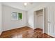 Bedroom featuring hardwood floors, a closet, and a window providing ample natural light at 2015 Twelve Oaks Nw Cir, Kennesaw, GA 30144