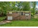 Charming brick home with a well-maintained lawn, inviting entrance, and one-car garage on a sunny day at 2015 Twelve Oaks Nw Cir, Kennesaw, GA 30144