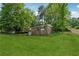 Expansive lawn surrounds this brick home, offering a serene setting with mature trees and landscaping at 2015 Twelve Oaks Nw Cir, Kennesaw, GA 30144
