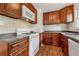Well-equipped kitchen with stainless sink, gas range, microwave, dark cabinets and laminate counter at 2015 Twelve Oaks Nw Cir, Kennesaw, GA 30144