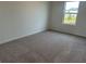 Cozy bedroom with neutral carpet and a window overlooking the neighborhood at 2105 Boxwood Se Cir, Conyers, GA 30094