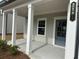 Inviting covered front porch with white columns and stylish front door at 2105 Boxwood Se Cir, Conyers, GA 30094